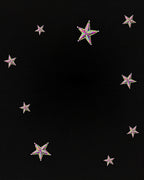Sparkling Multicolor Star Scatter Across Black Rug