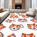 Playful Orange Tabby Kitten Faces Rug